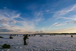 Fishermen fishing in winter on the ice 