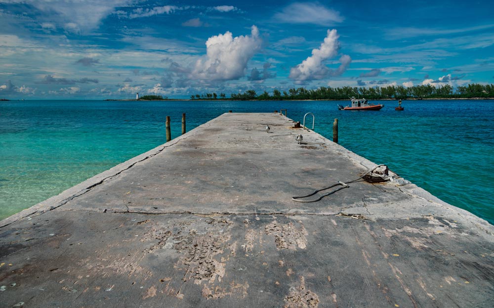 High angle shot of a pier with a cloudy blue sky in the background